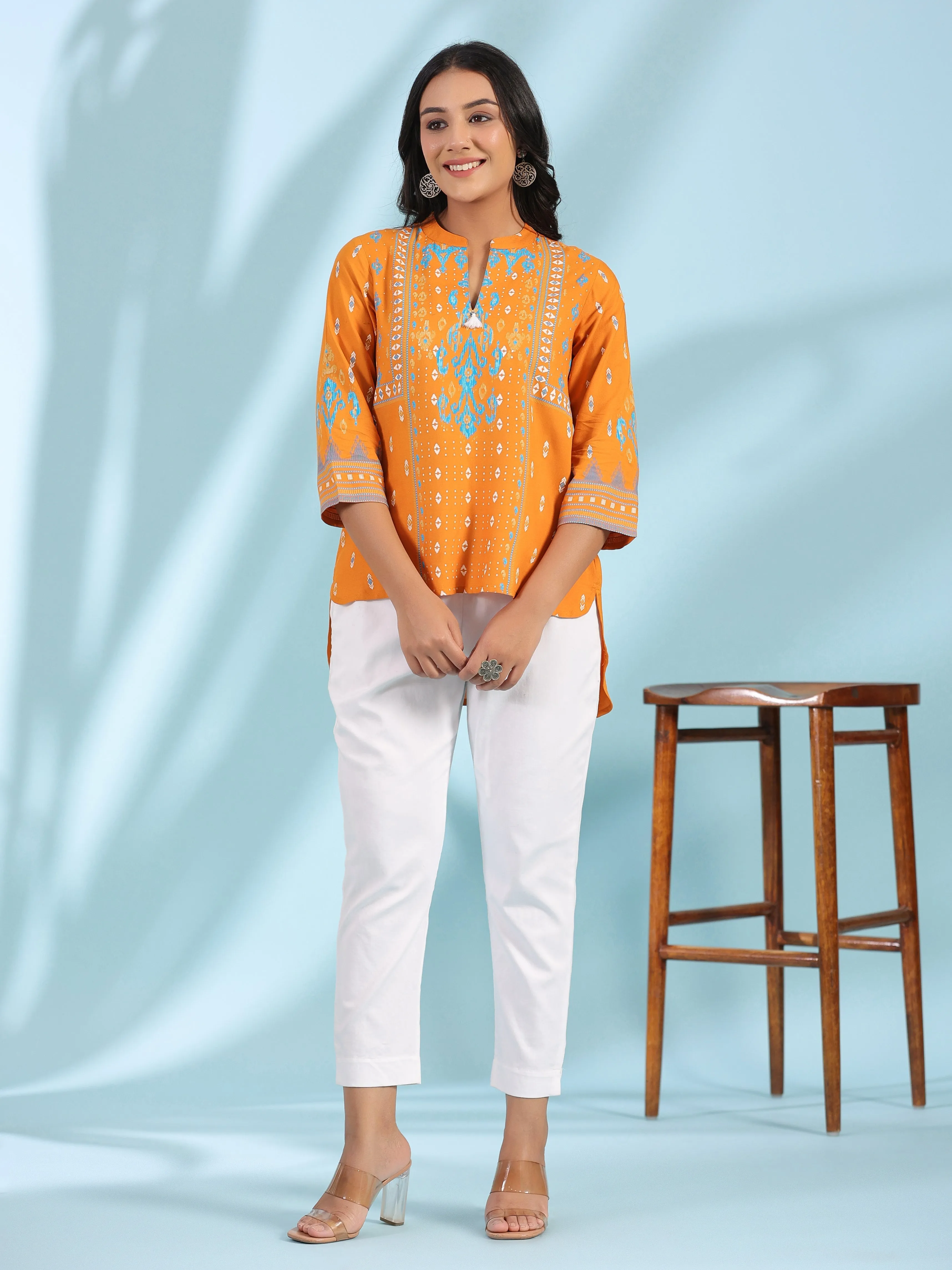 Jashvi Mustard Rayon Ikat Placement Printed High-Low Tunic With Side Slits & Tassels