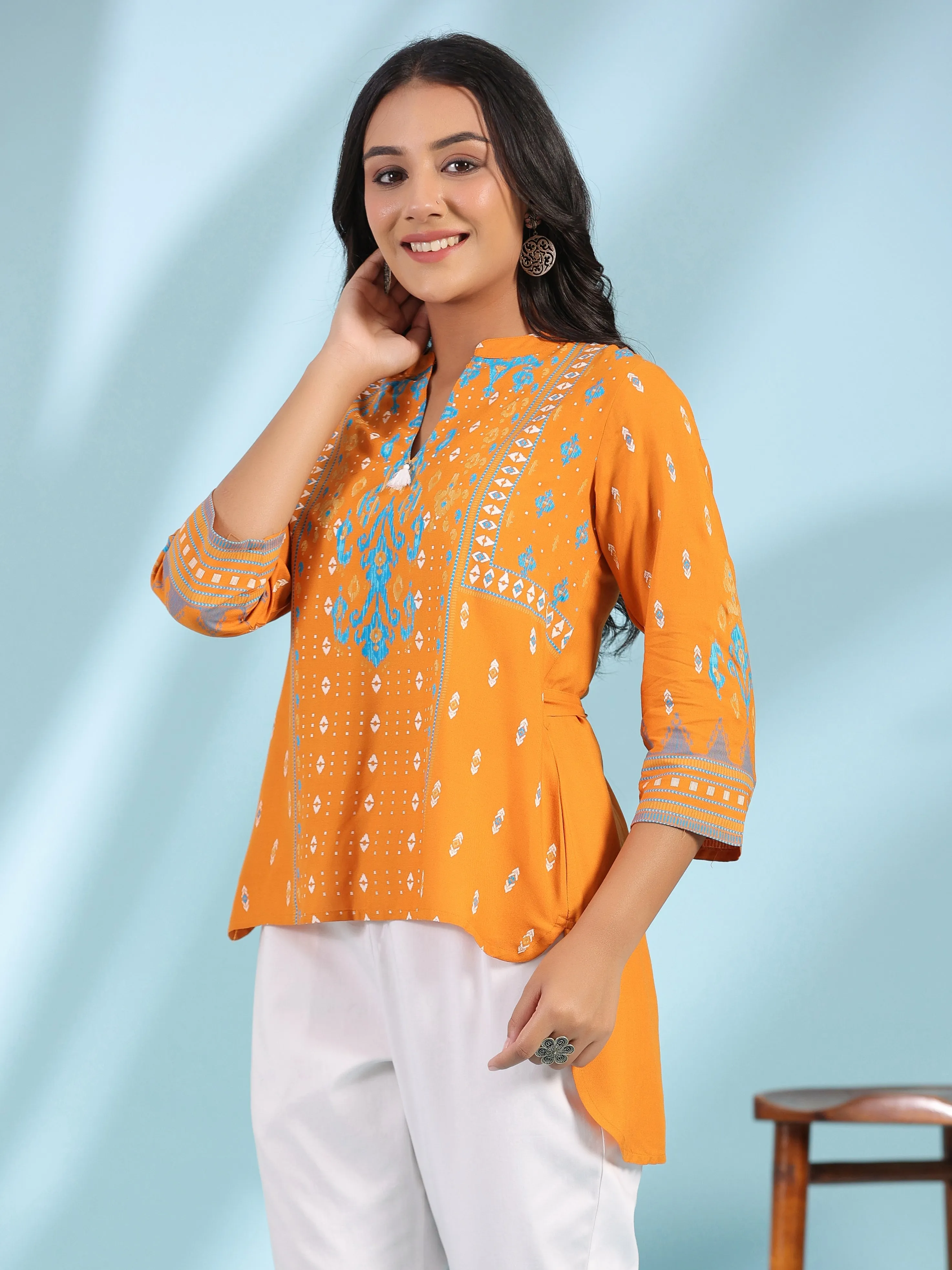 Jashvi Mustard Rayon Ikat Placement Printed High-Low Tunic With Side Slits & Tassels