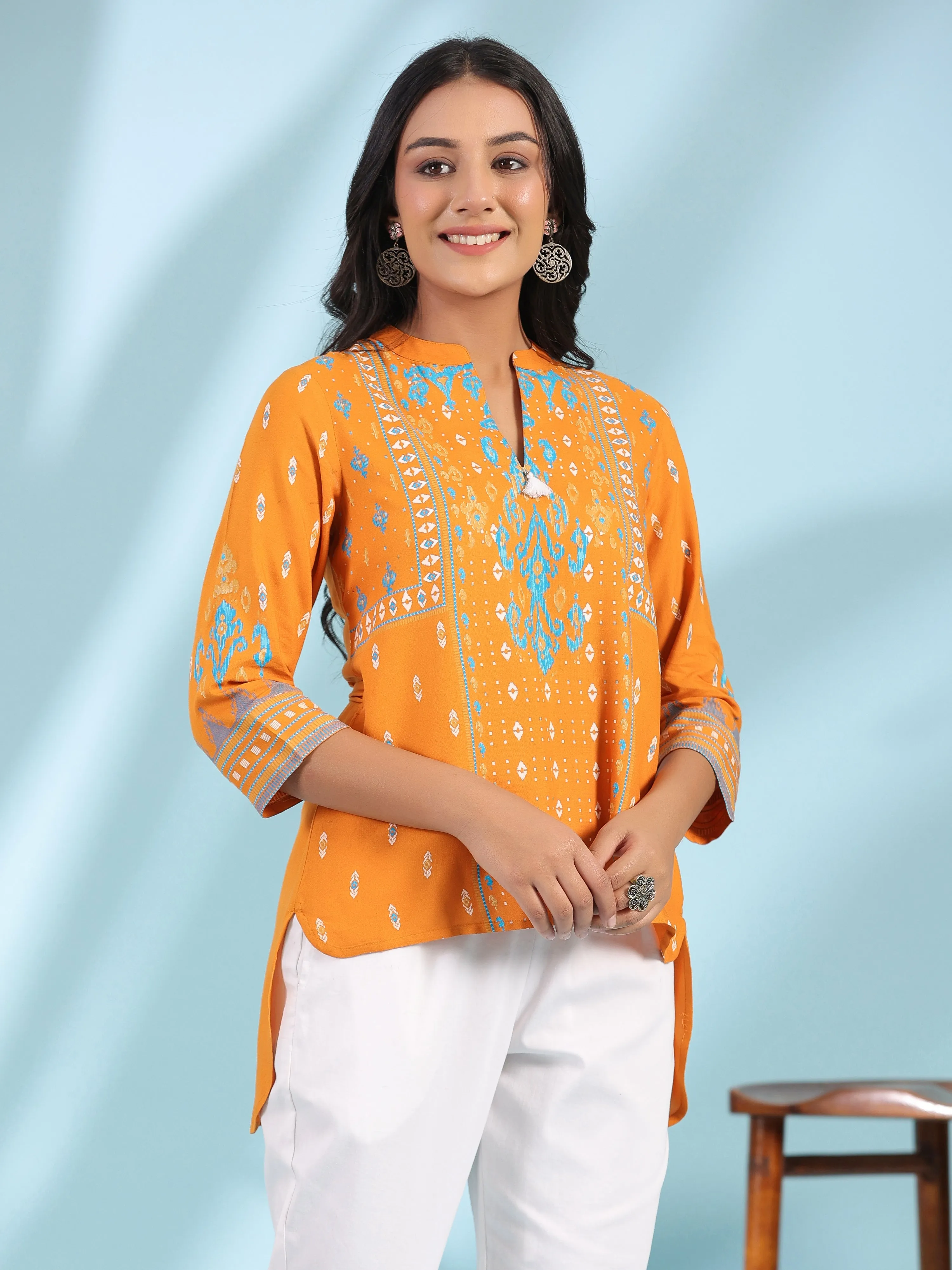 Jashvi Mustard Rayon Ikat Placement Printed High-Low Tunic With Side Slits & Tassels