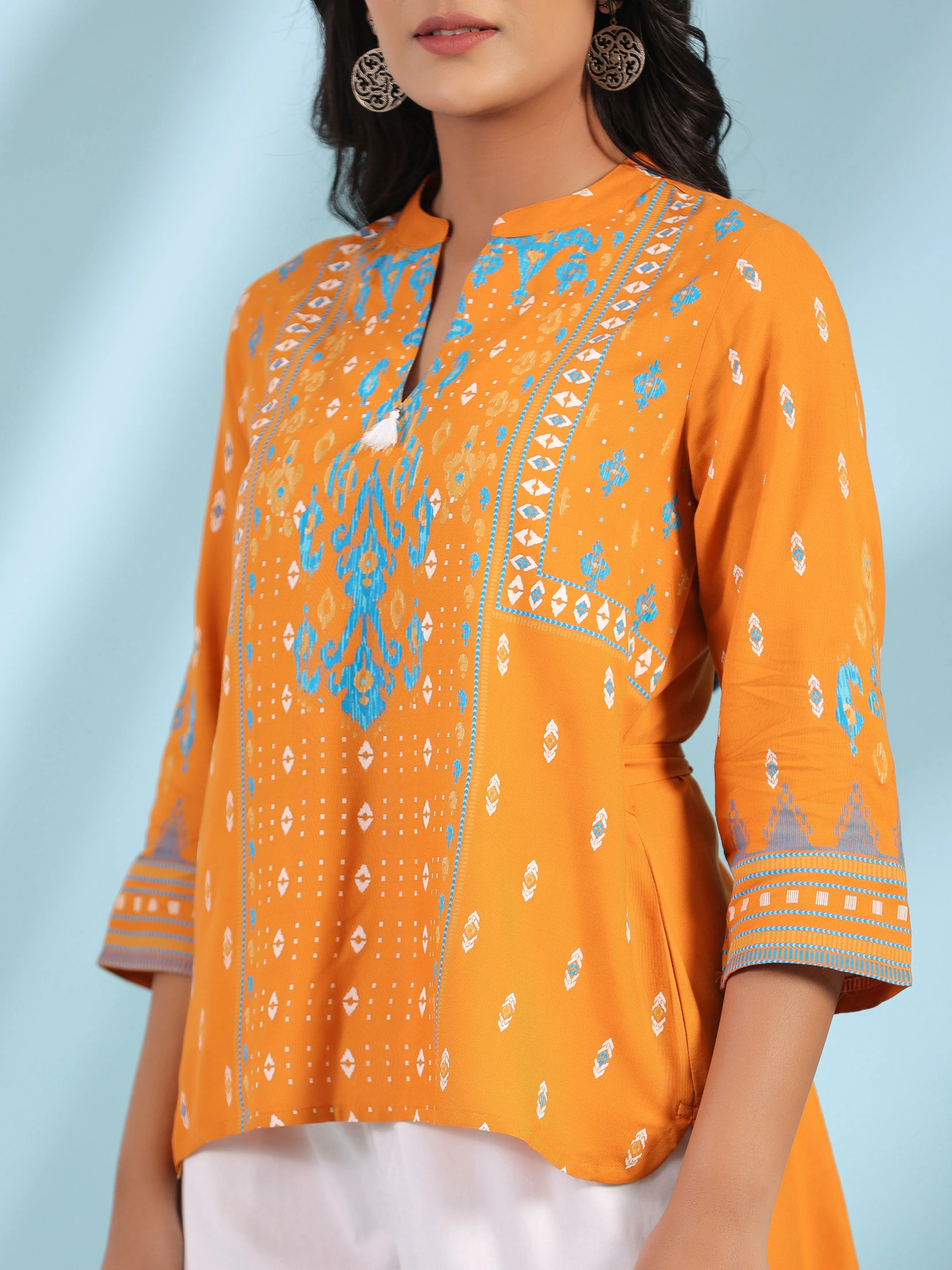 Jashvi Mustard Rayon Ikat Placement Printed High-Low Tunic With Side Slits & Tassels