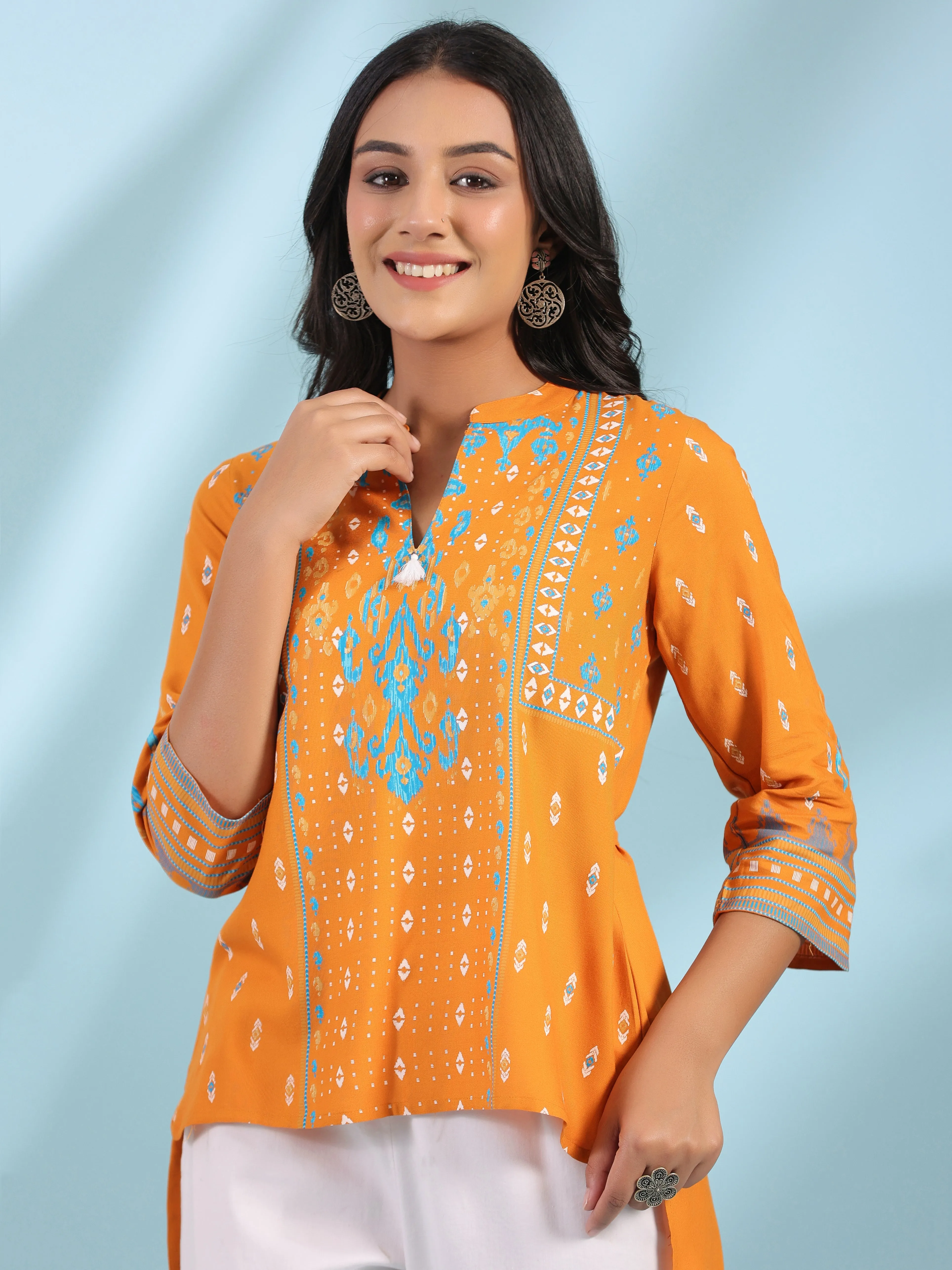 Jashvi Mustard Rayon Ikat Placement Printed High-Low Tunic With Side Slits & Tassels